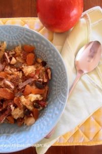 An image if Quinoa Porridge with Apples, dried figs, Apricots, nuts and seeds.