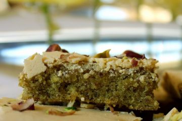 An image showing pieces of Pistachio Cake and daffodils in the background.