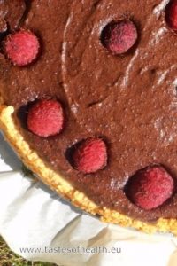 An image of Chocolate Tart with Millet and raspberries on top.
