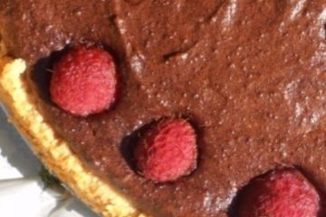 An image of Chocolate Tart with Millet and raspberries on top.