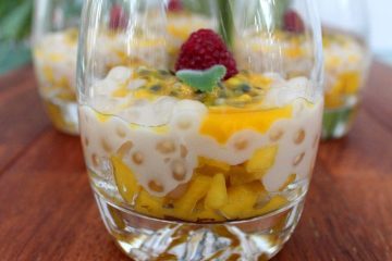 An image of Mango Coconut Tapioca Pudding in a glass seen from a side.