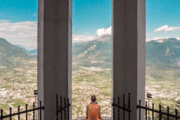 How to Meditate? - A photo of a man meditating while he admires a beautiful view on the mountains
