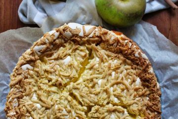 Is Healthier Baking Possible When You Want A Yummy Cake? A photo of a cake made with fat substitutes. There are 3 apples, 2 cinnamon sticks and a cloth next to the cake.