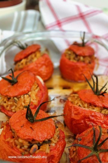 An image of Vegan Stuffed Tomatoes with Rice in a glass dish.