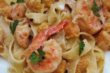 An image of Creamy Shrimp Pasta with Squash on a white plate.